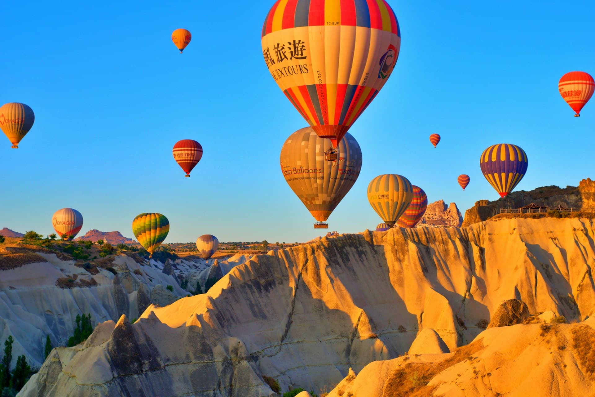Hot air balloons floating over fairy chimneys in Cappadocia at dawn